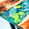 Handcrafted Koi Fish epoxy resin table, meticulously designed with crystal-clear resin, capturing the elegance of Koi fish swimming through flowing water. Combined with premium natural wood, this artistic masterpiece adds a unique touch to any space
