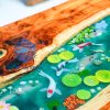 Close-up of a Koi Fish Swimming in Epoxy Resin on a Wooden Desk