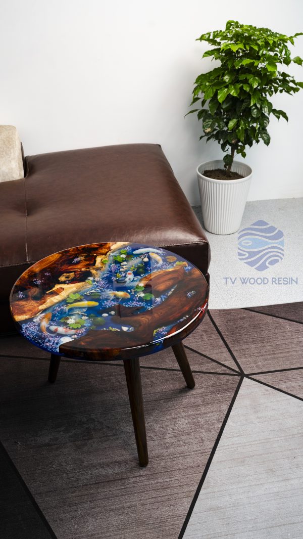 Unique wood and resin round table with captivating Hương wood grain, deep blue mystical water, characteristic Koi, and a special Peach dragon-fish element