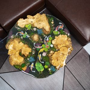Unique wood and resin round table with Koi fish, captivating burl knots, and mysterious moss, perfect for apartments