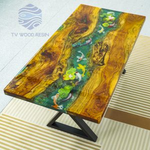 TV Wood Resin's iconic Koi fish art on a handcrafted desk