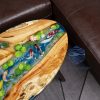 Handcrafted wood and resin oval coffee/side table featuring iconic Koi fish and yellow Tamarind wood
