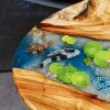 Handcrafted wood and resin oval coffee/side table featuring iconic Koi fish and yellow Tamarind wood