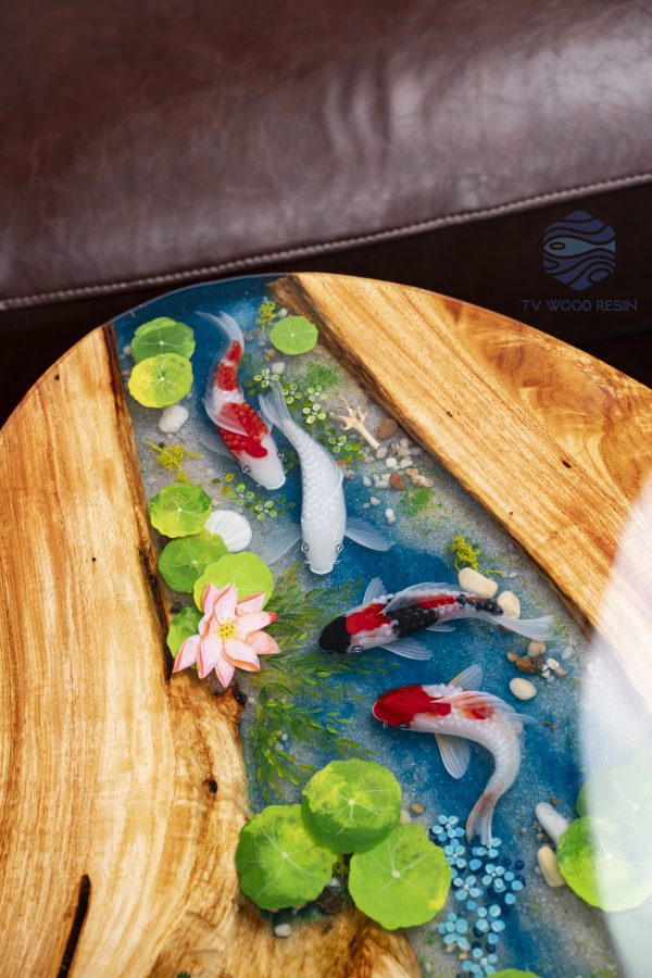 Handcrafted wood and resin oval coffee/side table featuring iconic Koi fish and yellow Tamarind wood