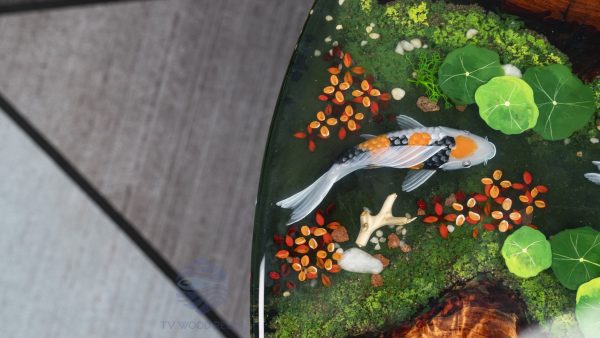 Handcrafted round coffee table for apartments, featuring iconic Koi fish, moss base, and rich red-brown Sưa wood