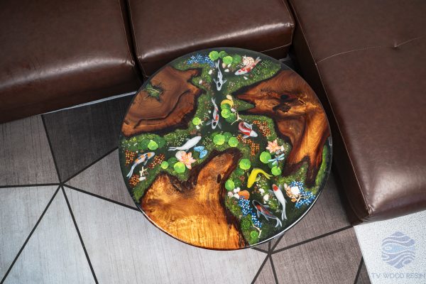 Handcrafted round coffee table for apartments, featuring iconic Koi fish, moss base, and rich red-brown Sưa wood