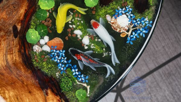 Handcrafted round coffee table for apartments, featuring iconic Koi fish, moss base, and rich red-brown Sưa wood