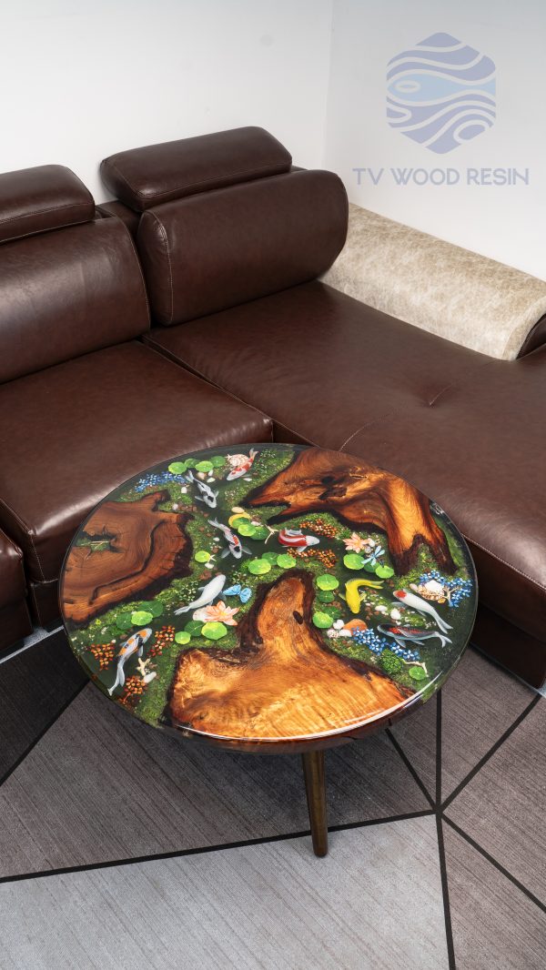 Handcrafted round coffee table for apartments, featuring iconic Koi fish, moss base, and rich red-brown Sưa wood
