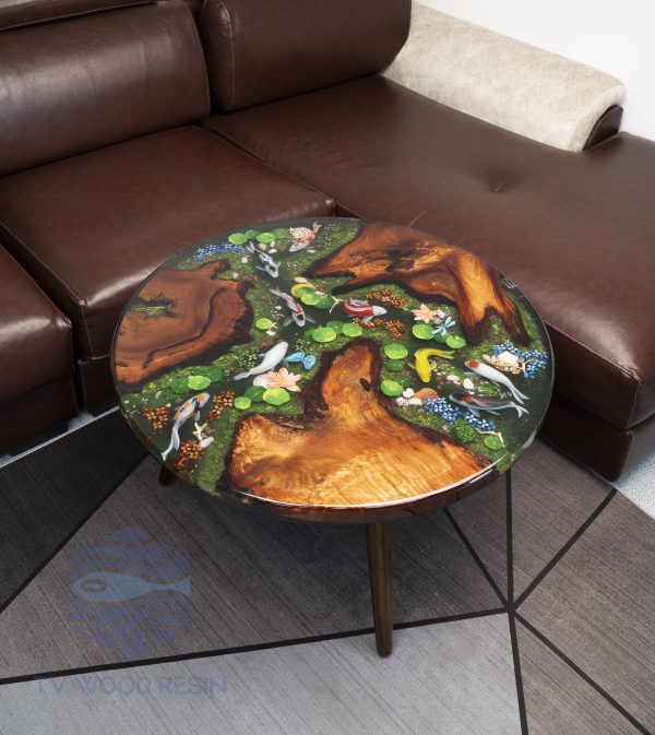 Handcrafted round coffee table for apartments, featuring iconic Koi fish, moss base, and rich red-brown Sưa wood